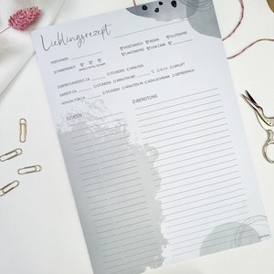 May include: A printable recipe template with a gray watercolor background. The template includes sections for the recipe name, serving size, difficulty level, preparation time, cooking time, cooling time, ingredients, and instructions. The template also includes checkboxes for vegetarian, vegan, gluten-free, lactose-free, and low carb.