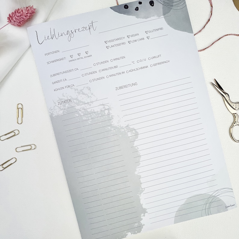May include: A printable recipe template with a gray watercolor background. The template includes sections for the recipe name, serving size, difficulty level, preparation time, cooking time, cooling time, ingredients, and instructions. The template also includes checkboxes for vegetarian, vegan, gluten-free, lactose-free, and low carb.
