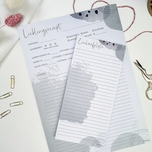 May include: A printable recipe and grocery list template with a gray and white abstract design. The template includes sections for recipe title, portions, difficulty, preparation time, cooking time, cooling time, and ingredients. The grocery list section has a lined area for writing.