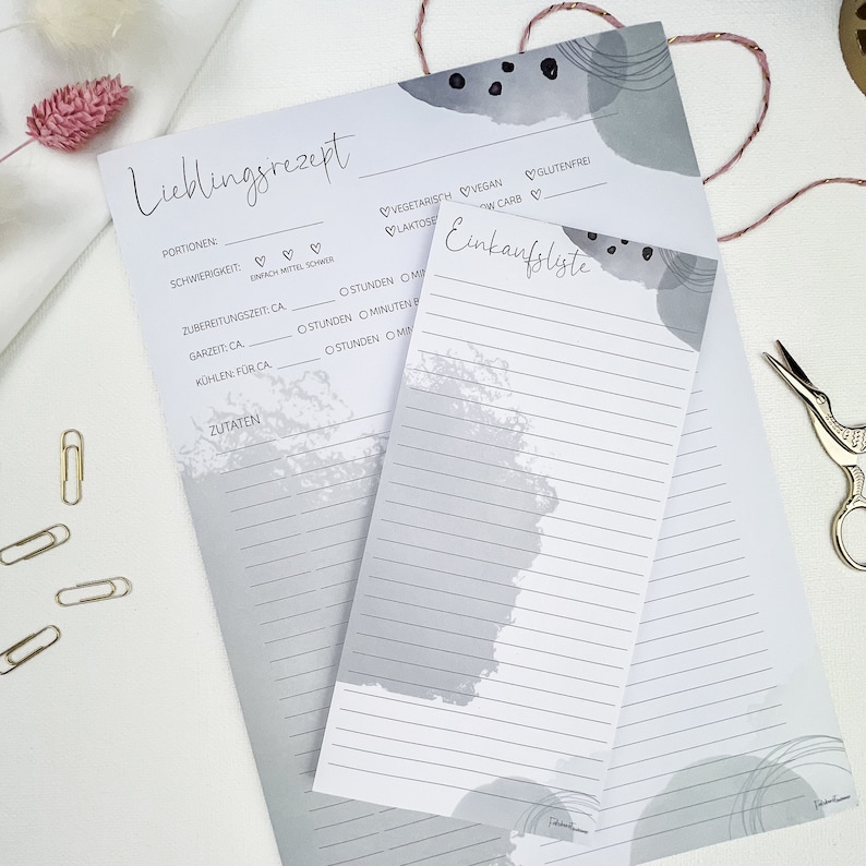 May include: A printable recipe and grocery list template with a gray and white abstract design. The template includes sections for recipe title, portions, difficulty, preparation time, cooking time, cooling time, and ingredients. The grocery list section has a lined area for writing.