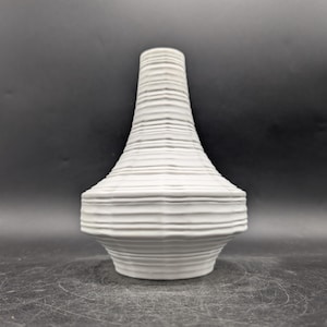 May include: A set of three ceramic nesting bowls in shades of blue, green, and white. The bowls have a speckled glaze and a simple, modern design. The largest bowl is approximately 15 cm in diameter.