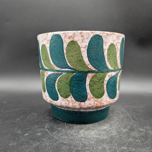 May include: A set of three ceramic mugs with a speckled, matte finish. The mugs are in shades of cream, light gray, and dark gray. Each mug has a simple, minimalist design, perfect for coffee or tea.