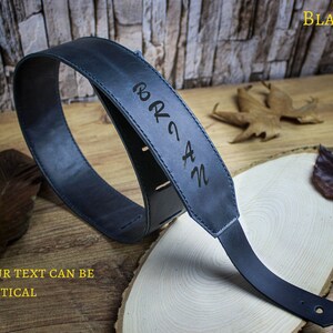 May include: Black leather guitar strap with the text "ORGAN" engraved in a vertical script font.