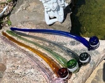 May include: Five glass smoking pipes in different colors, including blue, green, brown, and pink. The pipes are arranged in a rainbow pattern, with the blue pipe at the top and the pink pipe at the bottom. The pipes are all long and slender, with a curved bowl at the end.