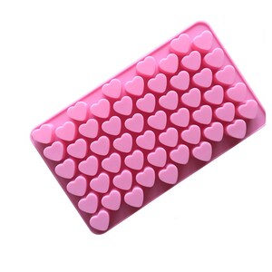 May include: Pink silicone mould with 50 heart-shaped cavities. The mould is designed for making chocolate, candy, or ice.