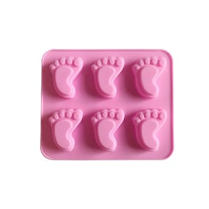 May include: Pink silicone mould with six baby footprint shapes.