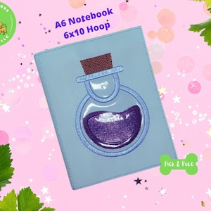 May include: A light blue A6 notebook cover with an embroidered design of a purple potion bottle with a cork stopper. The notebook cover is for a 6x10 hoop. The text "Pick & Poke Designs LLC" is in a green circle in the top left corner. The text "Pick & Poke" is in a green circle in the bottom right corner.