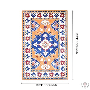 May include: A rectangular rug with a geometric pattern in shades of orange, blue, white, and red. The rug measures 3 feet by 5 feet.