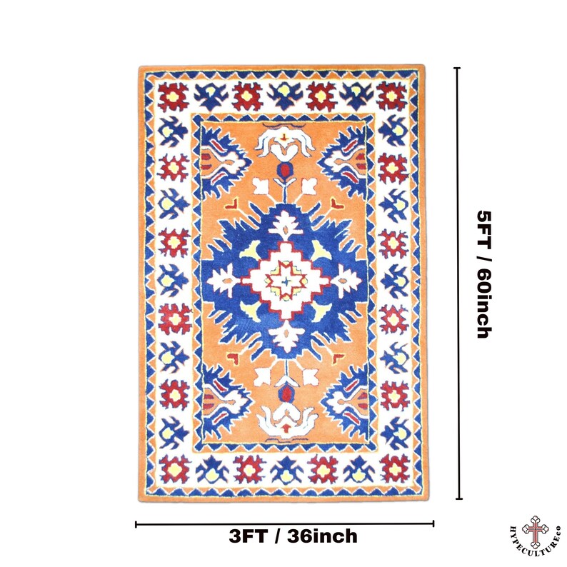 May include: A rectangular rug with a geometric pattern in shades of orange, blue, white, and red. The rug measures 3 feet by 5 feet.