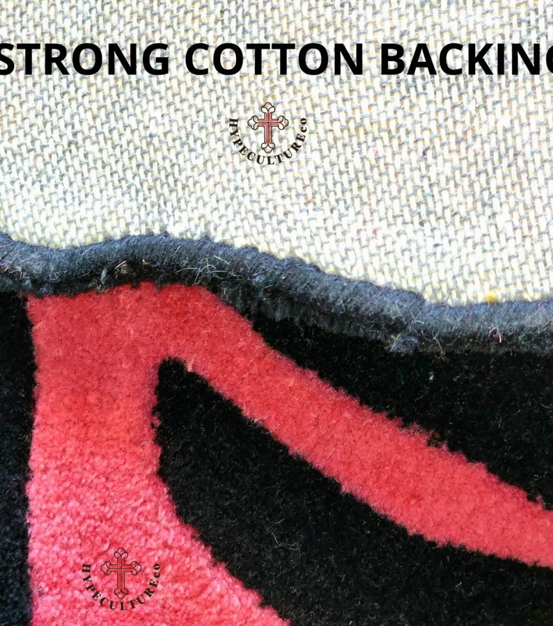 May include: Close-up of a black and red rug with a cotton backing. The rug has a geometric pattern and the text "HYPECULTURECO" is visible in the bottom right corner.