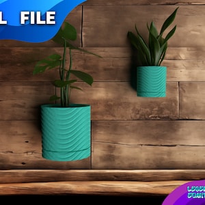 May include: Two teal-colored, textured, cylindrical planters with plants hanging on a wooden wall. The text .STL FILE is visible in the top left corner of the image.