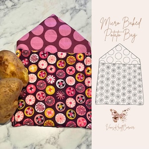 May include: A fabric Micro Baked Potato Bag with a floral and polka dot pattern. The bag is made of a dark burgundy fabric with pink, yellow, and white floral designs. The top flap is a dark burgundy with large pink polka dots. The text "Micro Baked Potato Bag" is visible.