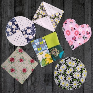 May include: Set of six colorful fabric coasters with various patterns, including floral, geometric, and polka dots. The coasters are made of cotton fabric and are perfect for protecting surfaces from heat and spills.