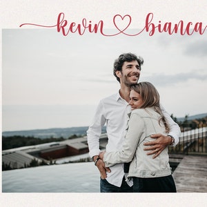 May include: A photograph featuring a couple embracing outdoors. The text "kevin & bianca" is written in red script above the image, with a heart symbol between the names. The words "SWEET MOMENT" are written vertically on the left side.