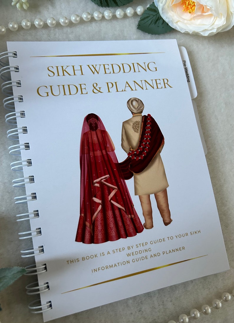 May include: A white spiral bound book with a gold title "Sikh Wedding Guide & Planner". The cover features an illustration of a bride and groom in traditional Sikh wedding attire. The text "This book is a step by step guide to your Sikh wedding information guide and planner" is printed in gold at the bottom of the cover.