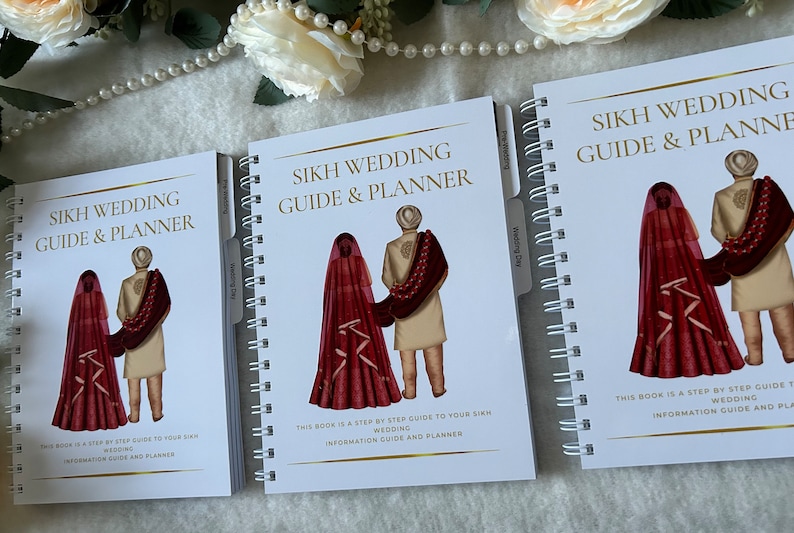 May include: Three white spiral bound notebooks with gold accents. Each notebook has a cover image of a Sikh couple in traditional wedding attire. The text on the cover reads "Sikh Wedding Guide & Planner".