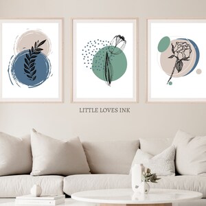 May include: Three abstract art prints with black line drawings of leaves, a tulip, and a rose. The prints have a white background with blue, green, and beige circles.