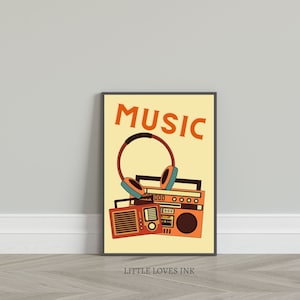 May include: A retro-style poster with the word "MUSIC" in orange letters on a yellow background. A vintage boombox and headphones are stacked on top of each other. The poster is framed in black.