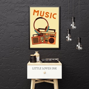 May include: A retro-style poster with the word "MUSIC" in orange letters on a yellow background. A vintage boombox and headphones are pictured below the word. The poster is framed in black.