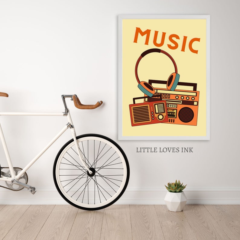 May include: A yellow poster with the word "MUSIC" in orange text. An orange and brown retro boombox with headphones is pictured below the text. The poster has the text "LITTLE LOVES INK" at the bottom.