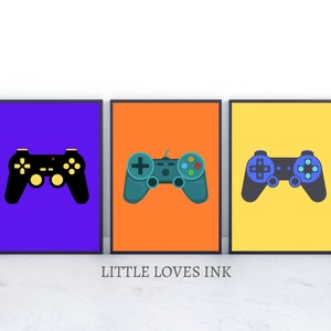 May include: Three framed prints of different colored backgrounds with a black, teal, and blue video game controller on each.