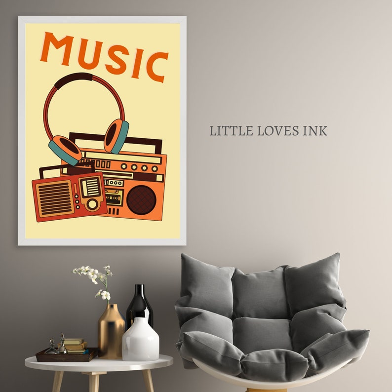 May include: A framed print with a yellow background featuring a retro boombox and headphones with the word "MUSIC" in orange letters. The print is titled "LITTLE LOVES INK".