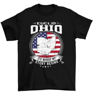 May include: Black t-shirt with a white, red, and blue American flag design featuring the state of Ohio. The text "EUCLID OHIO" is above the flag and "IT'S WHERE MY STORY BEGINS" is below the flag.