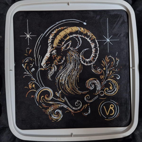 Elaborate embroidery design of the Capricorn zodiac sign, realistic, colorful, with light and shadow, for commercial use by LunaChild on dark fabrics