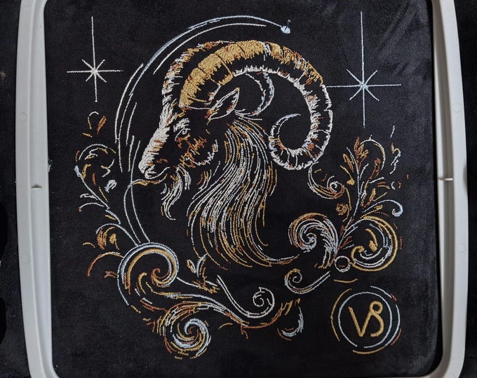 Elaborate embroidery design of the Capricorn zodiac sign, realistic, colorful, with light and shadow, for commercial use by LunaChild on dark fabrics