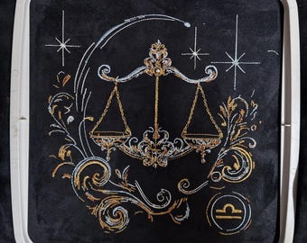 Elaborate embroidery design: realistic, colorful Libra zodiac sign with light and shadow. Commercial use by LunaChild for dark fabrics.
