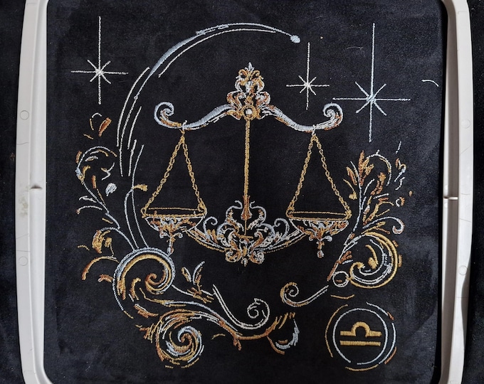 Elaborate embroidery design: realistic, colorful Libra zodiac sign with light and shadow. Commercial use by LunaChild for dark fabrics.