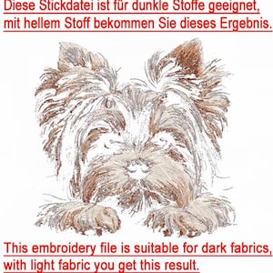 May include: Embroidery design of a Yorkshire Terrier dog's head. The text reads "This embroidery file is suitable for dark fabrics, with light fabric you get this result."