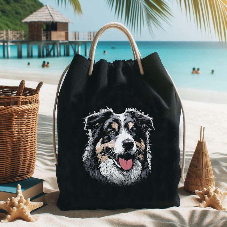 Stickmuster Hund für dunkle Stoffe, hochwertig umgesetzte Konturen-Stickerei auf einer modischen Tragetasche oder einem Gassi-Beutel vor einer idyllischen Meereskulisse mit türkisblauem Wasser von LunaChild.com
