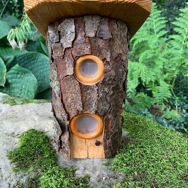 Two Story Log Fairy House with Multiple Windows that Glow at night from Solar Powered Lights