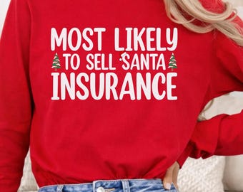 May include: A long-sleeve red shirt featuring the white text MOST LIKELY TO SELL SANTA INSURANCE with a small Santa hat icon on the word SANTA and two green Christmas tree graphics on either side of the middle line of text.