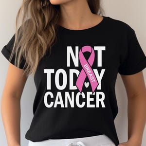 May include: Black t-shirt with a pink ribbon and the text "NOT TODAY CANCER" with the words "BREAST" inside the ribbon.