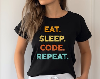 May include: Black t-shirt with a vintage-style graphic that reads "Eat. Sleep. Code. Repeat."