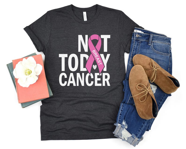 May include: A dark gray t-shirt with the text "Not Today Cancer" and a pink ribbon with the word "Breast" on it.