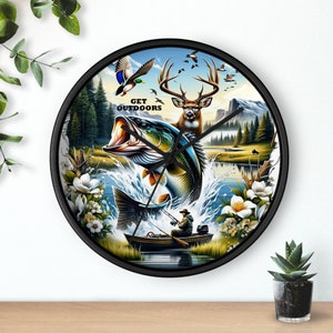 May include: A black and white clock with a colorful image of a deer, a fish jumping out of the water, and a fisherman in a boat. The clock face says "Get Outdoors".