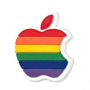 May include: A rainbow-colored apple logo charm with a white outline. The apple is made of rubber or plastic and has a glossy finish.