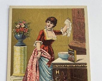 Antique Lavine Soap Trading Card featuring a Woman raising up her skirt and holding a hankie in her other hand