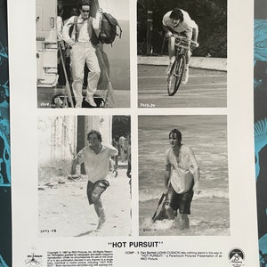 Op de afbeelding: Vier zwart-witfoto's van een man in verschillende scènes. De eerste foto toont de man die uit een vliegtuig stapt. De tweede foto toont de man op een fiets. De derde foto toont de man die op een strand rent. De vierde foto toont de man die in het water loopt. De tekst "HOT PURSUIT" is onderaan de afbeelding gedrukt.