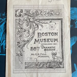 May include: A black and white image of a vintage advertisement for the Boston Museum. The advertisement features an ornate border with a floral design. The text reads "Boston Museum - Established 1841 - 50th Dramatic Season. Mr. R.M. Field, Manager."
