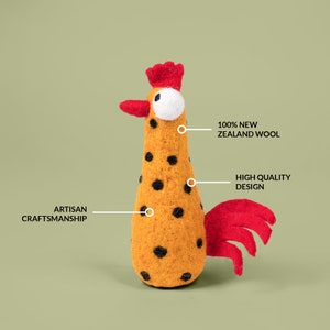 May include: A felt rooster toy with a red comb and tail, black polka dots on a yellow body, and the text "100% NEW ZEALAND WOOL", "HIGH QUALITY DESIGN", and "ARTISAN CRAFTSMANSHIP" on the image.