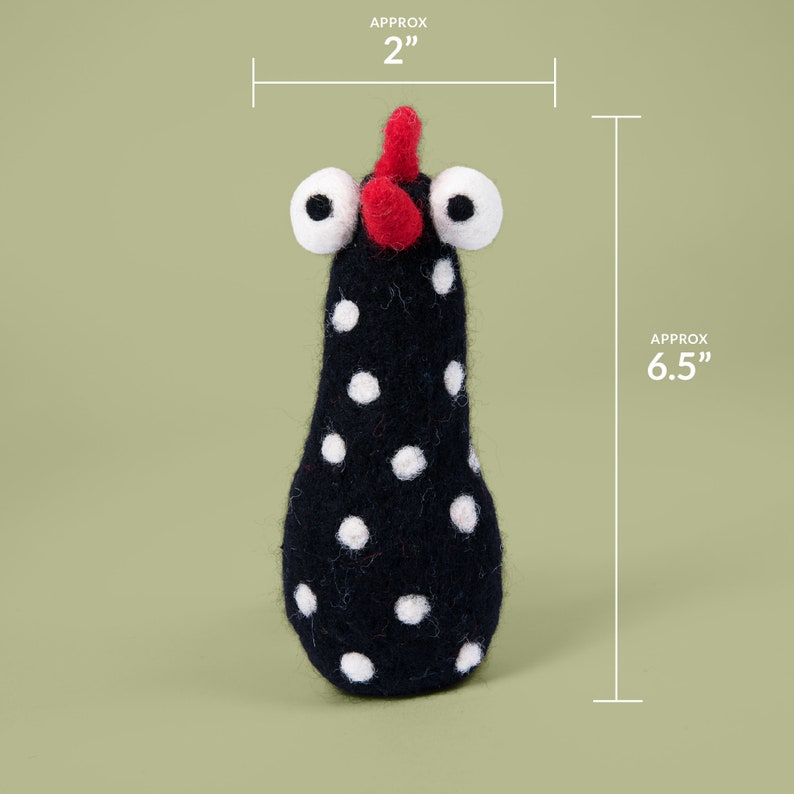 May include: Black and white polka dot felt chicken toy with red comb and large white eyes. The toy is approximately 6.5 inches tall and 2 inches wide.