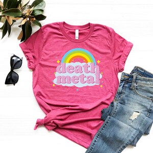 May include: Pink t-shirt with a rainbow and a cloud that says "death metal" in pink letters.
