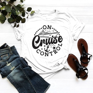 May include: White t-shirt with a black graphic of a cruise ship and the text "On Cruise Control" in a circle.