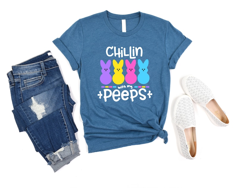 May include: A teal blue t-shirt with the text "Chillin with my peeps" and four colorful marshmallow peeps.