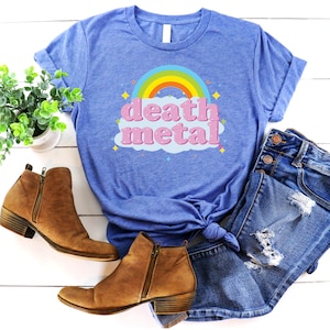 May include: A blue t-shirt with a rainbow and the words "death metal" in pink letters on a cloud.