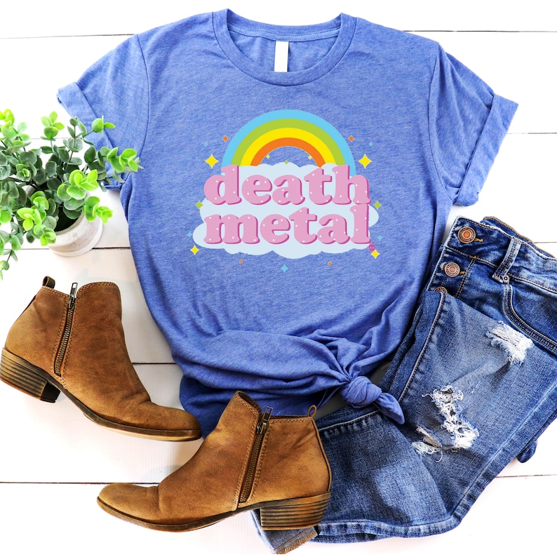 May include: A blue t-shirt with a rainbow and the words "death metal" in pink letters on a cloud.